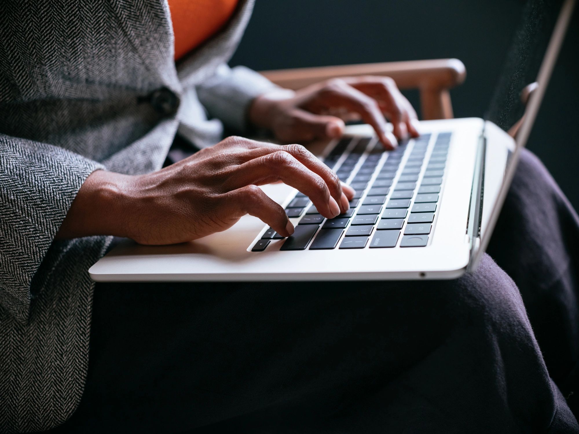 Professional writing website content on a laptop